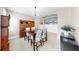Dining room with tile flooring, wood table, and hutch with chairs with floral covers at 17610 Buckingham Garden Dr, Lithia, FL 33547