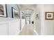 Bright and airy hallway featuring elegant archways, tile flooring, and stylish decor at 17610 Buckingham Garden Dr, Lithia, FL 33547