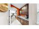 Well-lit kitchen with granite countertops, stainless steel appliances and plenty of dark wood cabinets at 17610 Buckingham Garden Dr, Lithia, FL 33547
