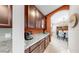 Kitchen featuring granite countertops and brown cabinetry at 17610 Buckingham Garden Dr, Lithia, FL 33547