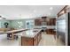 Open concept kitchen featuring a granite-topped island and stainless steel appliances at 17610 Buckingham Garden Dr, Lithia, FL 33547