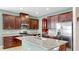 Spacious kitchen with a large island, stainless steel appliances, and brown cabinetry at 17610 Buckingham Garden Dr, Lithia, FL 33547