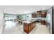Modern kitchen with a large island, stainless steel appliances and white tile floors at 17610 Buckingham Garden Dr, Lithia, FL 33547
