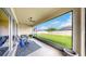 Relaxing lanai with comfortable seating overlooking a well-manicured backyard at 17610 Buckingham Garden Dr, Lithia, FL 33547