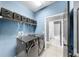 Modern laundry room boasting washer and dryer, storage shelf and view to the bathroom at 17610 Buckingham Garden Dr, Lithia, FL 33547