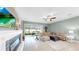 Well-lit living room and fireplace, a large sofa and view to the outside patio at 17610 Buckingham Garden Dr, Lithia, FL 33547