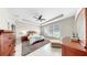 The main bedroom features a ceiling fan, natural light, and a comfortable seating area at 17610 Buckingham Garden Dr, Lithia, FL 33547