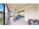 Relaxing covered patio featuring neutral tones, ceiling fan, comfortable seating, and screened windows at 17610 Buckingham Garden Dr, Lithia, FL 33547