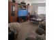 Inviting living room with a large entertainment center, plush seating, and a cozy atmosphere at 18063 Parrot Rd, Weeki Wachee, FL 34614