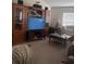 Inviting living room with a large entertainment center, plush seating, and a cozy atmosphere at 18063 Parrot Rd, Weeki Wachee, FL 34614