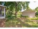 Secluded backyard featuring a detached garage and partial view of a screened-in porch at 1815 Durant Rd, Valrico, FL 33596