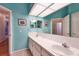 Spacious bathroom with double sinks, tiled floors, and colorful decor at 1815 Durant Rd, Valrico, FL 33596