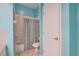 Aqua bathroom featuring a shower/tub combo and floral shower curtain at 1815 Durant Rd, Valrico, FL 33596