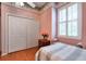 Bright bedroom featuring light pink walls and a large closet with sliding doors at 1815 Durant Rd, Valrico, FL 33596