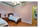 Well-lit bedroom features two twin beds, hardwood floors, and a doorway at 1815 Durant Rd, Valrico, FL 33596