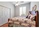 Bedroom offers a closet, window with plantation shutters, and plush bedding at 1815 Durant Rd, Valrico, FL 33596