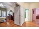 Bright bedroom with hardwood floors and multiple doorways at 1815 Durant Rd, Valrico, FL 33596