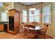 Cozy dining area features wood furniture, shuttered windows, and classic wallpaper at 1815 Durant Rd, Valrico, FL 33596