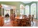 Elegant dining room with a large table, chandelier, and natural light at 1815 Durant Rd, Valrico, FL 33596