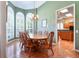 Dining room with a large wooden table and view into the kitchen at 1815 Durant Rd, Valrico, FL 33596