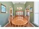 Formal dining room with a large table, china cabinet, and elegant decor at 1815 Durant Rd, Valrico, FL 33596