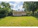 Two-car detached garage surrounded by a green lawn and mature trees, providing ample parking at 1815 Durant Rd, Valrico, FL 33596