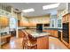 Bright kitchen features wood cabinets, black appliances, granite counters, island, and a dining area at 1815 Durant Rd, Valrico, FL 33596