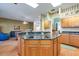 Spacious kitchen features wood cabinets, black granite countertops, island cooktop, and hardwood floors at 1815 Durant Rd, Valrico, FL 33596