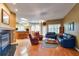 Spacious living room with hardwood floors, fireplace, and access to the kitchen and dining area at 1815 Durant Rd, Valrico, FL 33596