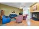 Comfortable living room featuring hardwood floors, blue sofas, and a cozy fireplace at 1815 Durant Rd, Valrico, FL 33596