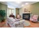 Cozy living room with fireplace, piano, and comfortable seating arrangement at 1815 Durant Rd, Valrico, FL 33596