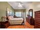 Bright main bedroom features a ceiling fan, hardwood floors, and large windows at 1815 Durant Rd, Valrico, FL 33596