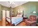 Spacious main bedroom featuring hardwood floors, a ceiling fan, and comfortable seating area at 1815 Durant Rd, Valrico, FL 33596