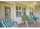 Relaxing patio with a door and windows, furnished with cushioned chairs and tile flooring at 1815 Durant Rd, Valrico, FL 33596