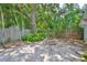 Lush backyard featuring a stone fire pit, mature trees, and well-maintained landscaping at 1825 2Nd S St, St Petersburg, FL 33705