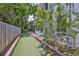 Charming backyard with bocce ball court and garden, framed by mature trees at 1825 2Nd S St, St Petersburg, FL 33705