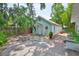 Charming backyard featuring a fire pit, detached building, and mature trees at 1825 2Nd S St, St Petersburg, FL 33705