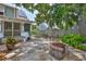 Beautifully landscaped backyard with a fire pit, pavers, and established greenery at 1825 2Nd S St, St Petersburg, FL 33705