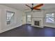 Sunlit bedroom with a fireplace, dark floors and multiple windows at 1825 2Nd S St, St Petersburg, FL 33705