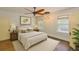 Staged bedroom with natural light, bed, side tables, rug, overhead lighting, and hardwood floors at 1825 2Nd S St, St Petersburg, FL 33705