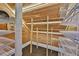 A custom cedar closet with wood paneling, built-in shelving, and overhead lighting offers luxurious storage space at 1825 2Nd S St, St Petersburg, FL 33705