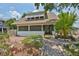 Inviting home with well-kept landscaping and a charming yellow front door at 1825 2Nd S St, St Petersburg, FL 33705