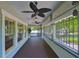 Long, covered front porch with dark wood flooring and charming light fixtures at 1825 2Nd S St, St Petersburg, FL 33705