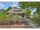 Beautifully landscaped front yard with a brick path leading to the inviting home at 1825 2Nd S St, St Petersburg, FL 33705