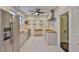 A charming kitchen features stainless steel appliances, custom cabinets and floating shelves, and white hexagon tile floors at 1825 2Nd S St, St Petersburg, FL 33705