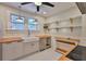 A charming kitchen features stainless steel appliances, custom cabinets and floating shelves, and a farmhouse sink at 1825 2Nd S St, St Petersburg, FL 33705
