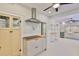 Open kitchen with butcher block counters, stainless hood vent, and views to other spaces at 1825 2Nd S St, St Petersburg, FL 33705