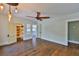 A spacious bedroom with hardwood floors, ample natural light, a ceiling fan, and a door to a cedar closet at 1825 2Nd S St, St Petersburg, FL 33705