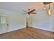 A spacious bedroom with hardwood floors, ample natural light, a ceiling fan, and multiple doors to other rooms at 1825 2Nd S St, St Petersburg, FL 33705