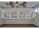 Bright porch featuring a ceiling fan and multiple windows with a view to the outdoors at 1825 2Nd S St, St Petersburg, FL 33705